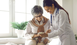 Woman with her doctor looking at a cell phone